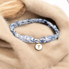 Bracelet en liberty avec une jolie croix dans un cercle